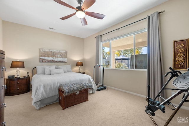 bedroom featuring visible vents, baseboards, carpet, and a ceiling fan