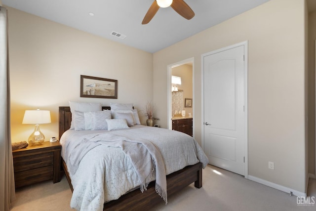 bedroom featuring visible vents, light carpet, ensuite bath, baseboards, and ceiling fan