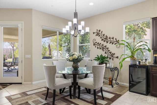 dining room featuring light tile patterned floors, a notable chandelier, wine cooler, and baseboards