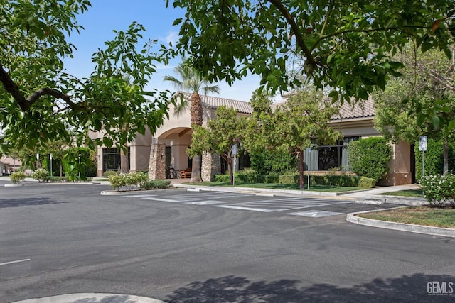 view of building exterior featuring uncovered parking