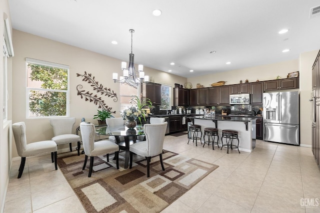 dining room with light tile patterned floors, a chandelier, and recessed lighting