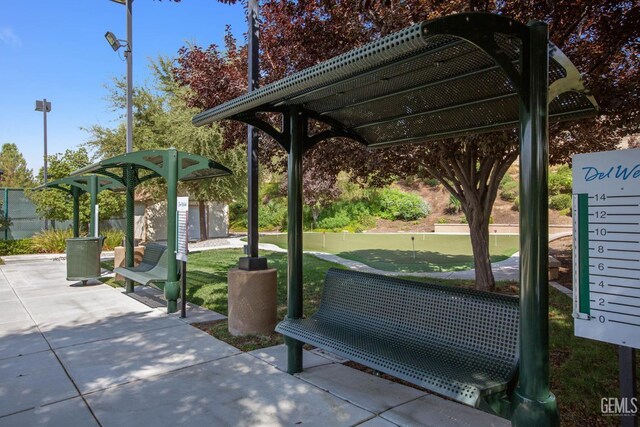 view of property's community featuring a patio and fence