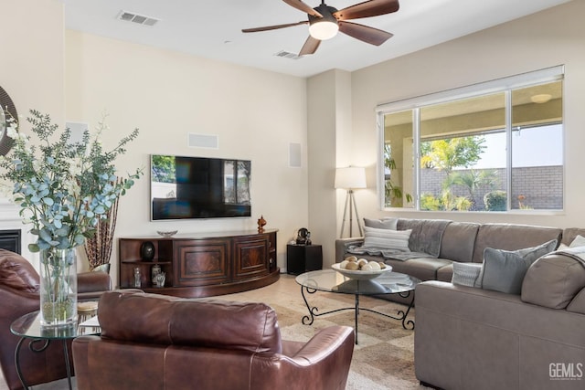 living room featuring visible vents and a ceiling fan