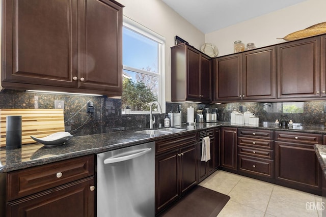 kitchen featuring dark stone counters, light tile patterned flooring, a sink, decorative backsplash, and dishwasher