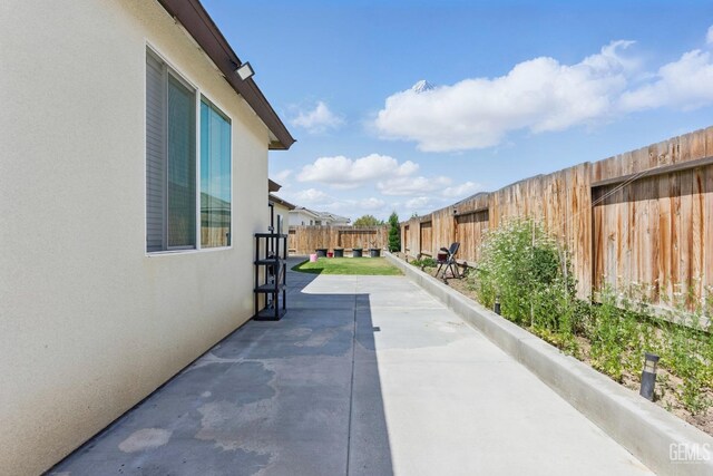 7900 Linden Tree Ave, Bakersfield, CA 93313 - view of home's exterior featuring a patio area, a fenced backyard, and stucco siding
