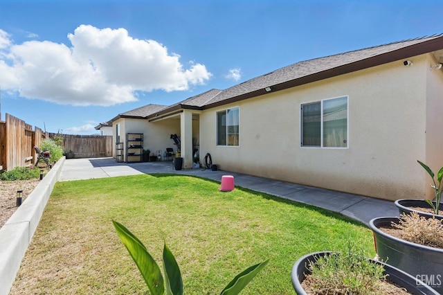7900 Linden Tree Ave, Bakersfield, CA 93313 - back of house featuring a fenced backyard, a yard, a patio area, and stucco siding