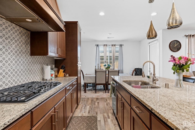 7900 Linden Tree Ave, Bakersfield, CA 93313 - kitchen featuring light stone counters, a sink, extractor fan, light wood-style floors, and stainless steel appliances