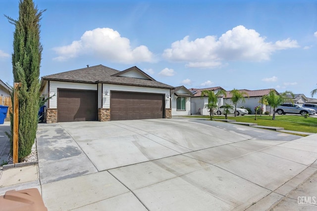 7900 Linden Tree Ave, Bakersfield, CA 93313 - view of front of house featuring a garage, stone siding, and concrete driveway