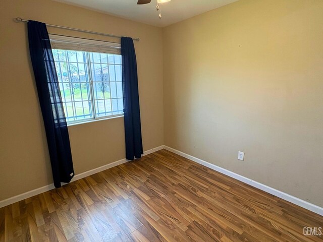 9057 Mackenzie Ct, Bakersfield, CA 93306 - unfurnished room featuring baseboards, wood finished floors, and ceiling fan