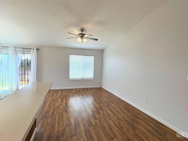 9057 Mackenzie Ct, Bakersfield, CA 93306 - unfurnished room with ceiling fan, baseboards, and dark wood finished floors