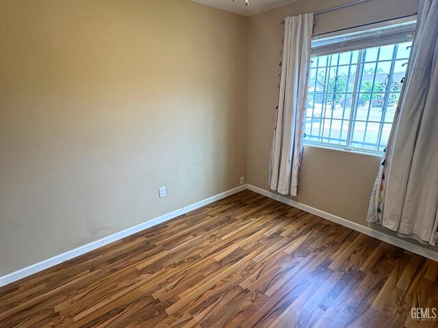 9057 Mackenzie Ct, Bakersfield, CA 93306 - empty room with wood finished floors and baseboards