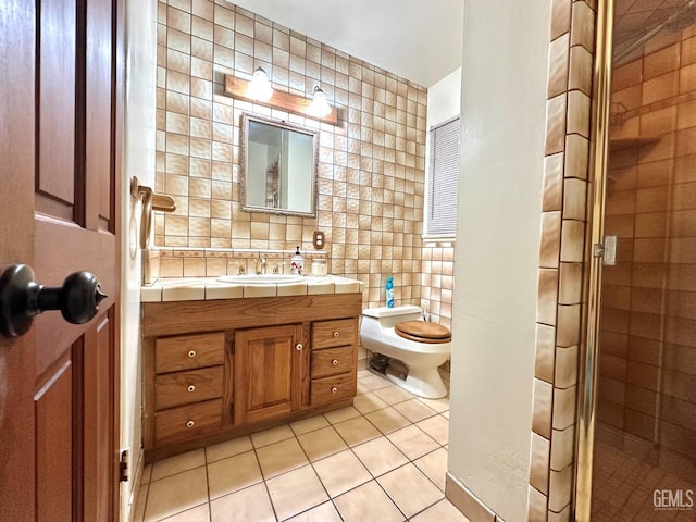 615 Cypress St, Bakersfield, CA 93304 - full bathroom with tile walls, tile patterned floors, a stall shower, toilet, and vanity