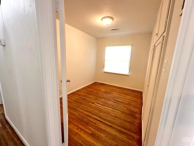 615 Cypress St, Bakersfield, CA 93304 - unfurnished bedroom with dark wood-type flooring, baseboards, and a closet