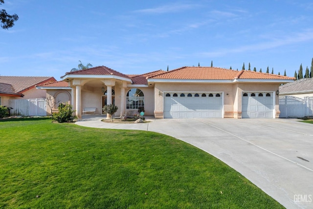 mediterranean / spanish-style house featuring an attached garage, a tiled roof, driveway, stucco siding, and a front lawn