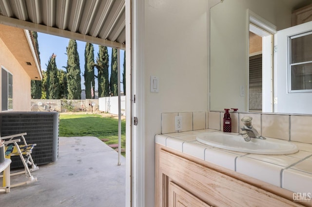 bathroom with a wealth of natural light, a sink, and concrete floors