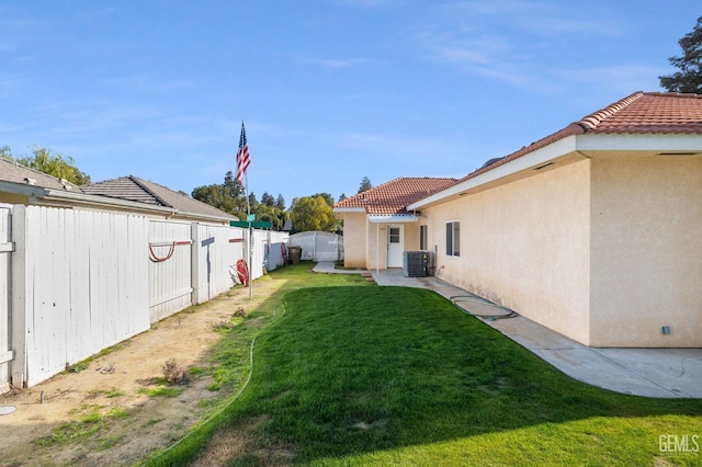 view of yard featuring central AC and a fenced backyard