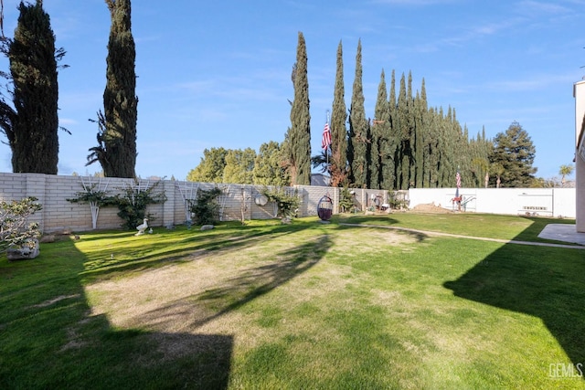 view of yard with a fenced backyard