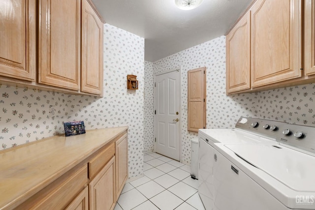 laundry room featuring light tile patterned flooring, cabinet space, separate washer and dryer, and wallpapered walls