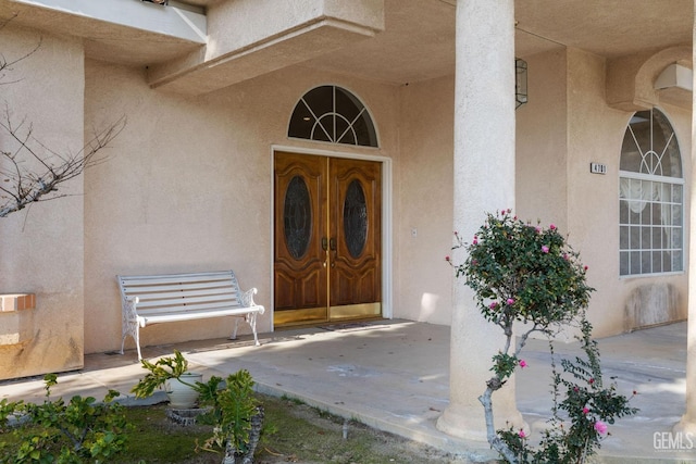 entrance to property featuring stucco siding