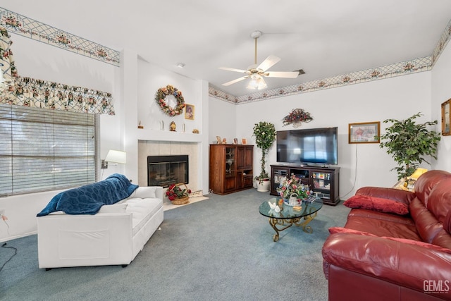 living area with ceiling fan, carpet, and a fireplace