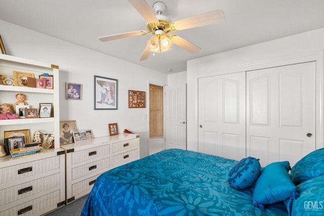 carpeted bedroom with ceiling fan and a closet