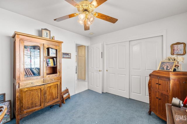 interior space featuring dark carpet and ceiling fan