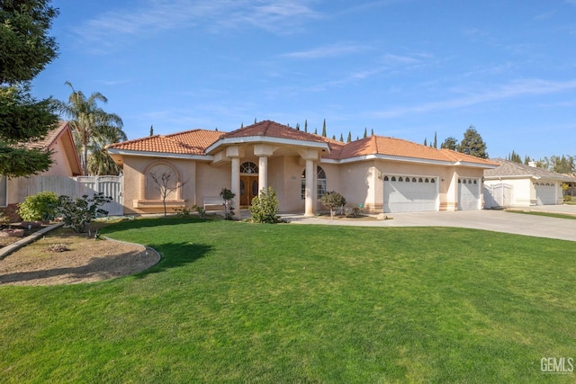 mediterranean / spanish-style house with concrete driveway, stucco siding, an attached garage, fence, and a front yard