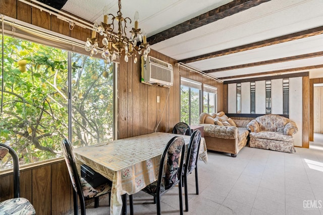 dining space with a wall unit AC, wooden walls, a notable chandelier, and beamed ceiling