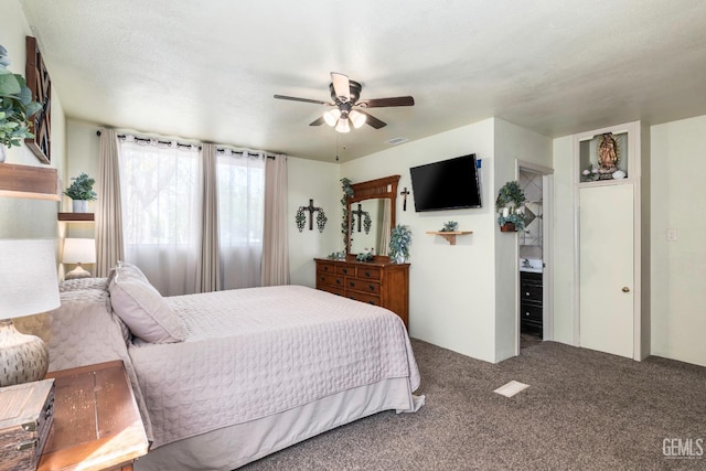 carpeted bedroom featuring ceiling fan and visible vents
