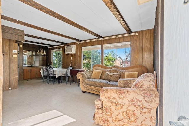 living area with an inviting chandelier, a wall mounted AC, wood walls, tile patterned floors, and beam ceiling