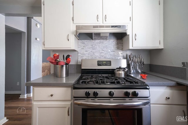 819 P St, Bakersfield, CA 93304 - kitchen featuring under cabinet range hood, stainless steel gas stove, white cabinets, dark wood-type flooring, and tasteful backsplash