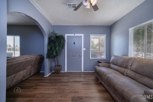 819 P St, Bakersfield, CA 93304 - living room featuring arched walkways, wood finished floors, ceiling fan, a textured ceiling, and healthy amount of natural light