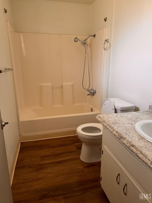 819 P St, Bakersfield, CA 93304 - bathroom with toilet, wood finished floors, vanity, and washtub / shower combination