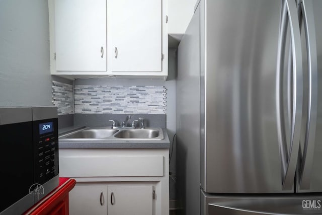 819 P St, Bakersfield, CA 93304 - kitchen with stainless steel appliances, a sink, white cabinets, and tasteful backsplash