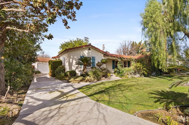 mediterranean / spanish-style house featuring a front yard