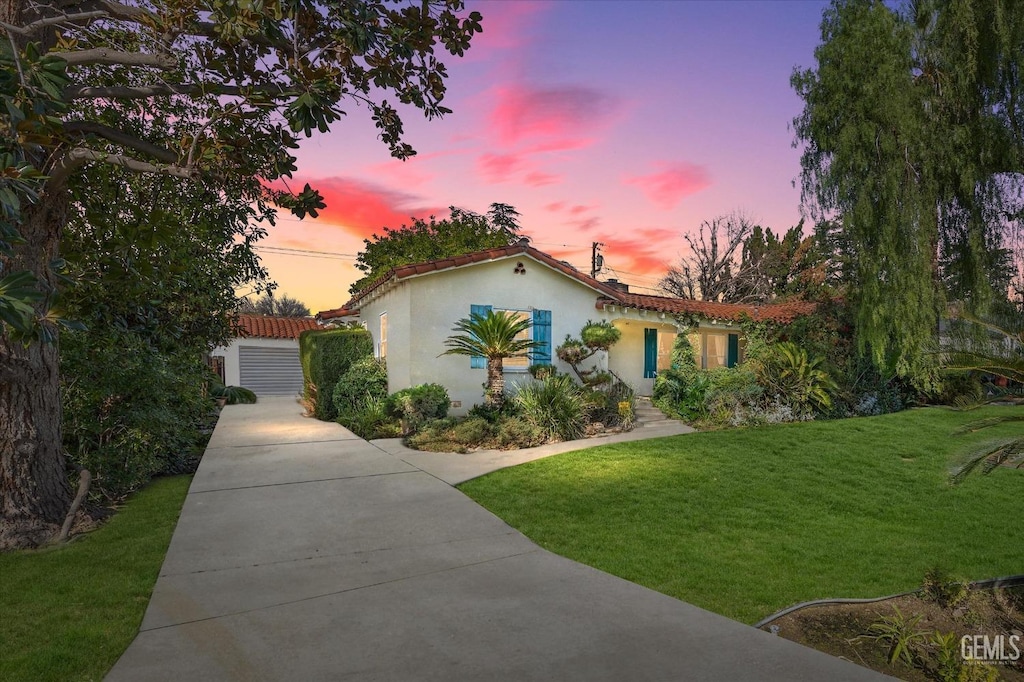 mediterranean / spanish-style home with a yard