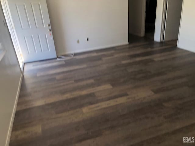 interior space featuring dark wood finished floors and baseboards