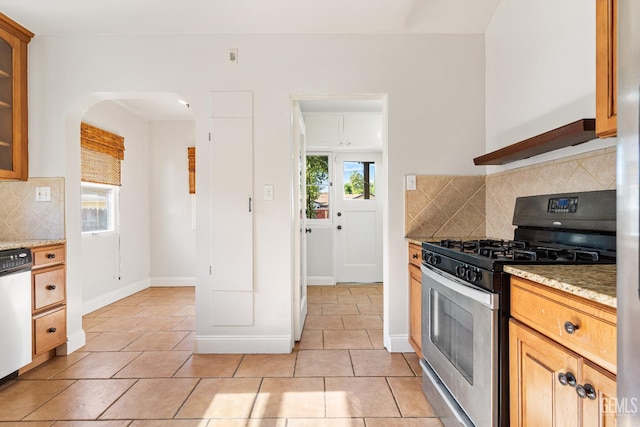 3007 Park Way, Bakersfield, CA 93304 - kitchen featuring stainless steel range with gas cooktop, dishwashing machine, tasteful backsplash, arched walkways, and light tile patterned floors
