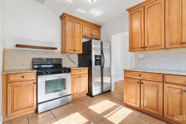 3007 Park Way, Bakersfield, CA 93304 - kitchen with appliances with stainless steel finishes, light stone counters, backsplash, and light tile patterned flooring