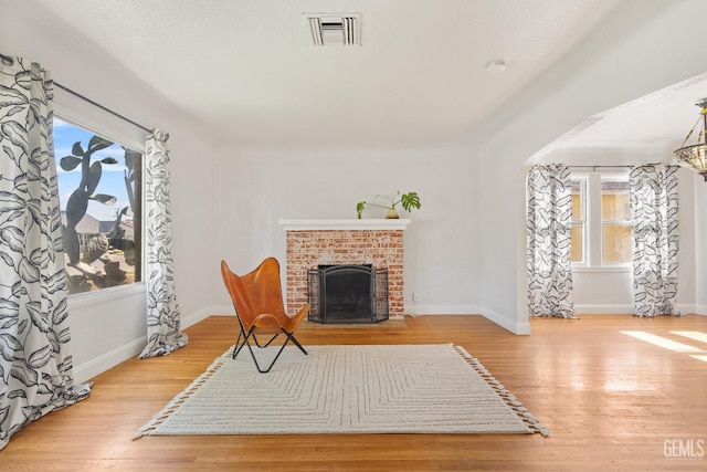 3007 Park Way, Bakersfield, CA 93304 - unfurnished room featuring wood finished floors, a brick fireplace, and baseboards