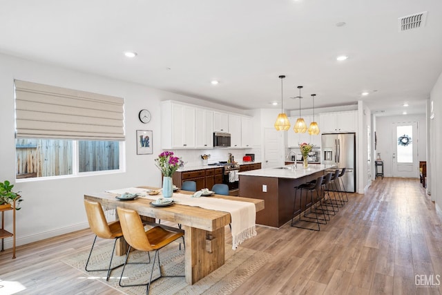 6713 Diamond Springs Dr, Bakersfield, CA 93313 - kitchen with stainless steel appliances, a kitchen island with sink, a sink, light wood-type flooring, and recessed lighting
