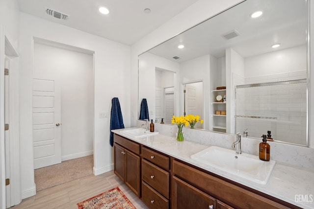 6713 Diamond Springs Dr, Bakersfield, CA 93313 - bathroom with double vanity, wood finished floors, recessed lighting, baseboards, and tiled shower