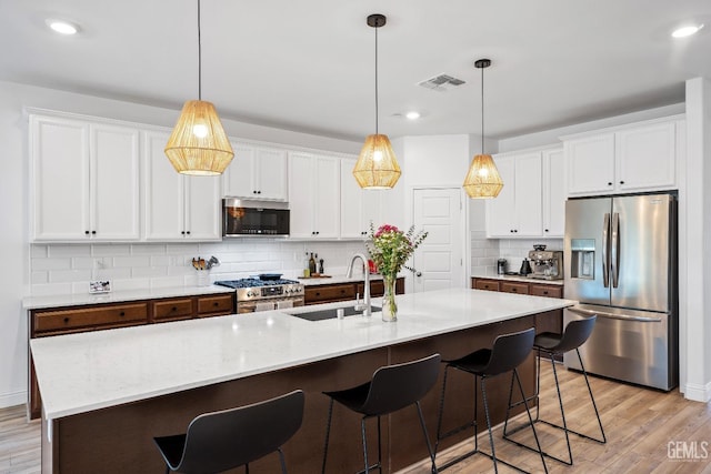 6713 Diamond Springs Dr, Bakersfield, CA 93313 - kitchen with appliances with stainless steel finishes, a sink, tasteful backsplash, white cabinets, and recessed lighting