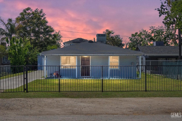 view of front facade featuring cooling unit, a front yard, and a fenced front yard
