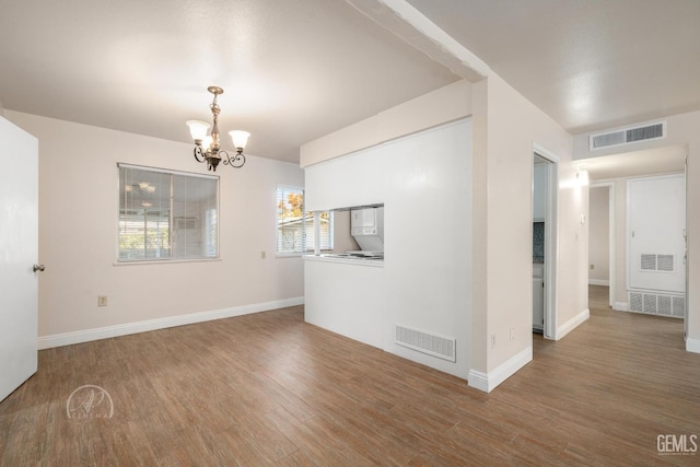 interior space with a chandelier and hardwood / wood-style floors