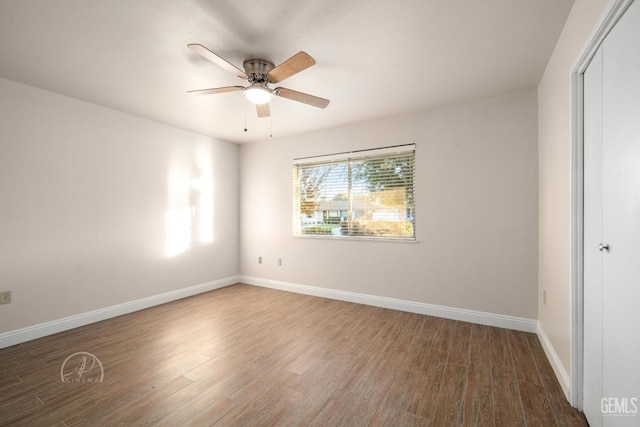 spare room with hardwood / wood-style flooring and ceiling fan