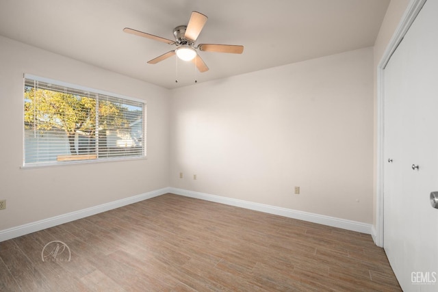 unfurnished bedroom with ceiling fan, hardwood / wood-style floors, and a closet