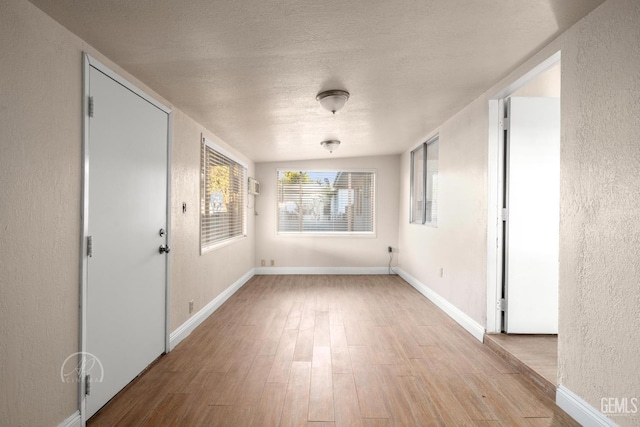 interior space with light hardwood / wood-style flooring and a textured ceiling