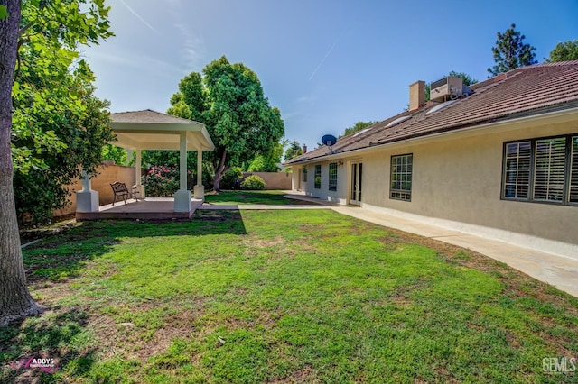 view of yard featuring a gazebo, a patio area, and fence