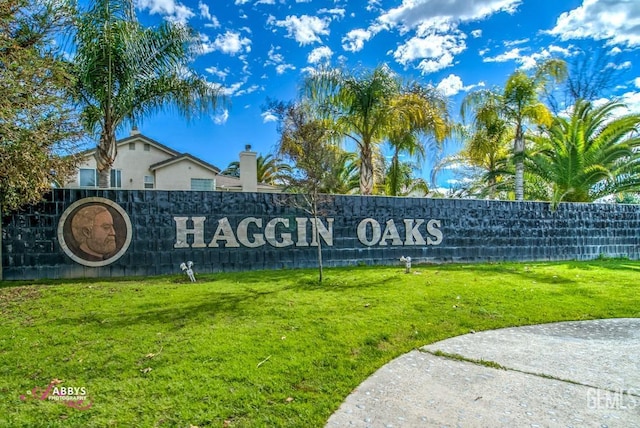 community / neighborhood sign with a lawn
